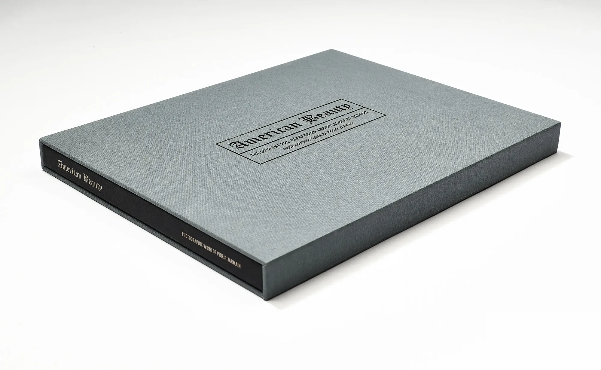 Slipcased hardcover in gunmetal grey
