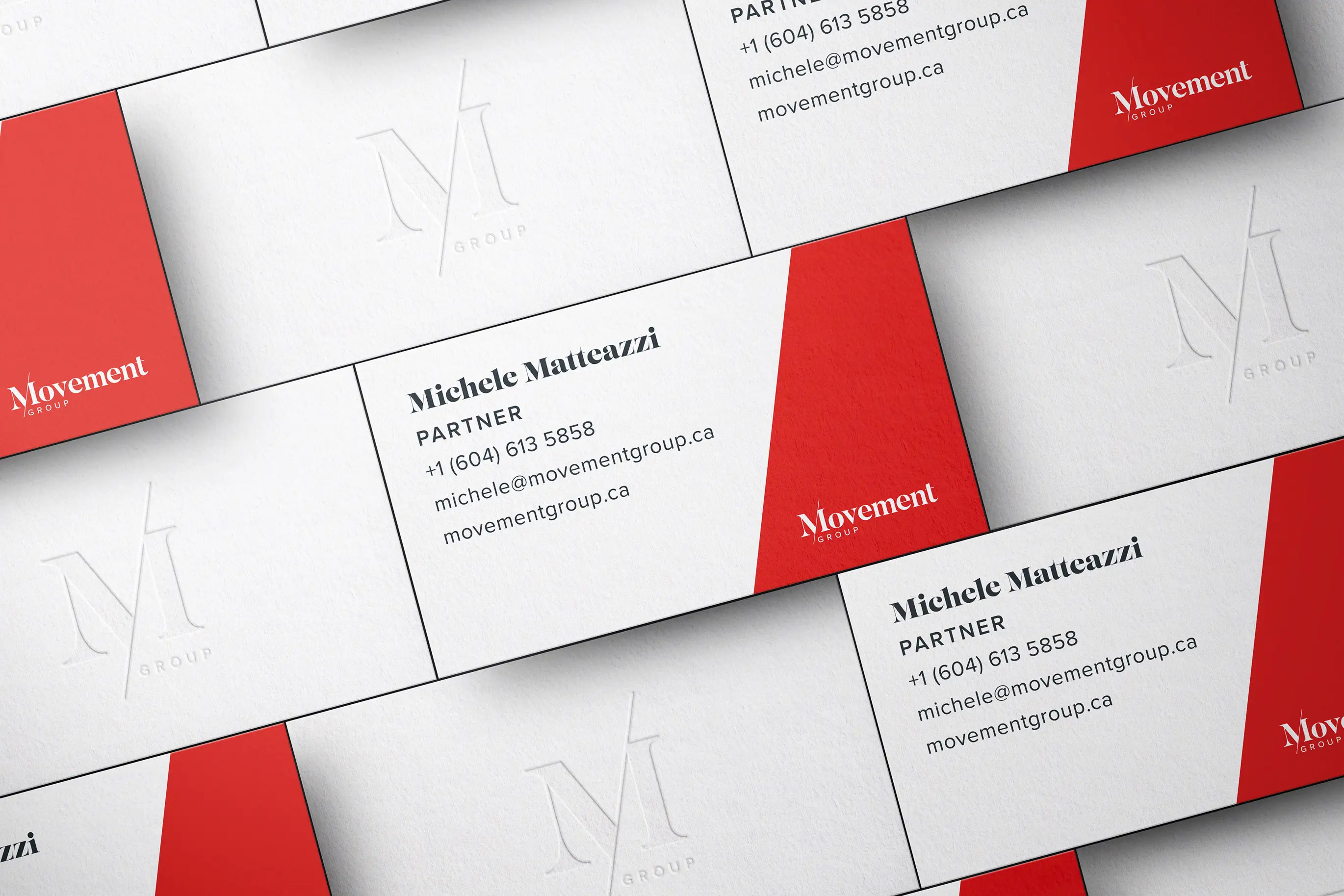 Movement Group blind embossed business cards with red reverse